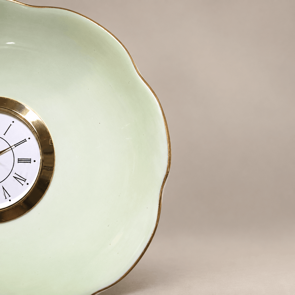 Celadon china plate clock with a pale-green scalloped plate, slender gold rim and gold Roman numeral clock face