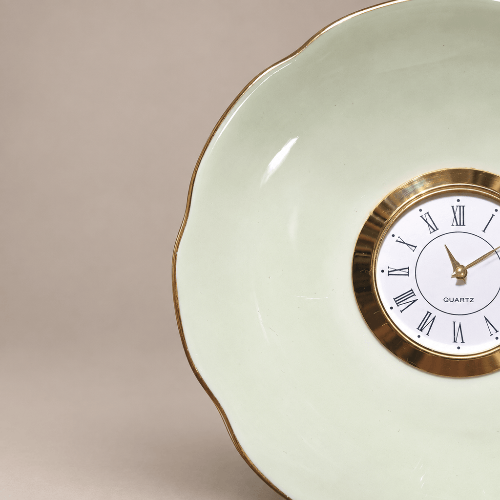 Celadon china plate clock with a pale-green scalloped plate, slender gold rim and gold Roman numeral clock face
