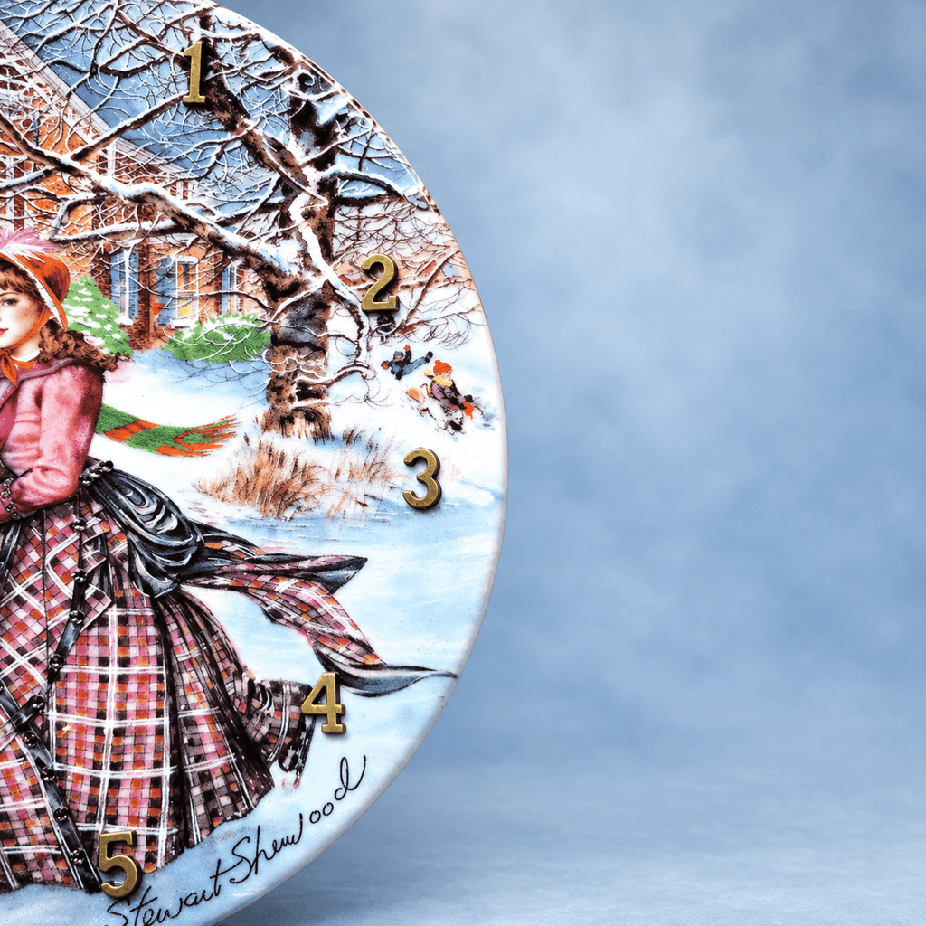Skating on the Pond collector plate clock featuring Victorian ice skaters, a child on a sleigh and a snowy home