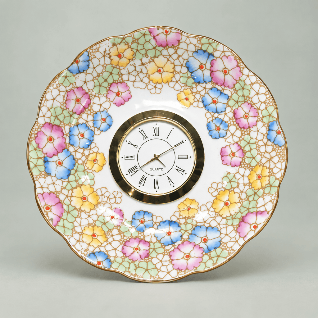 Pastel mosaic china plate clock with pink, blue and yellow flowers, mint-green accents and a gold Roman numeral clock face