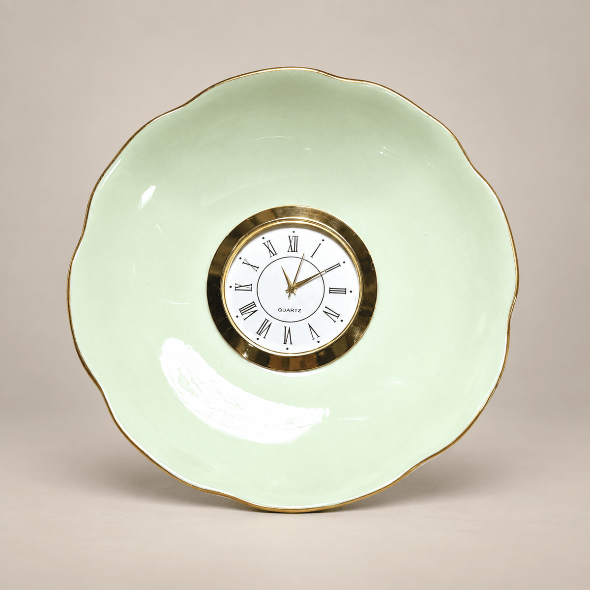 Celadon china plate clock with a pale-green scalloped plate, slender gold rim and gold Roman numeral clock face