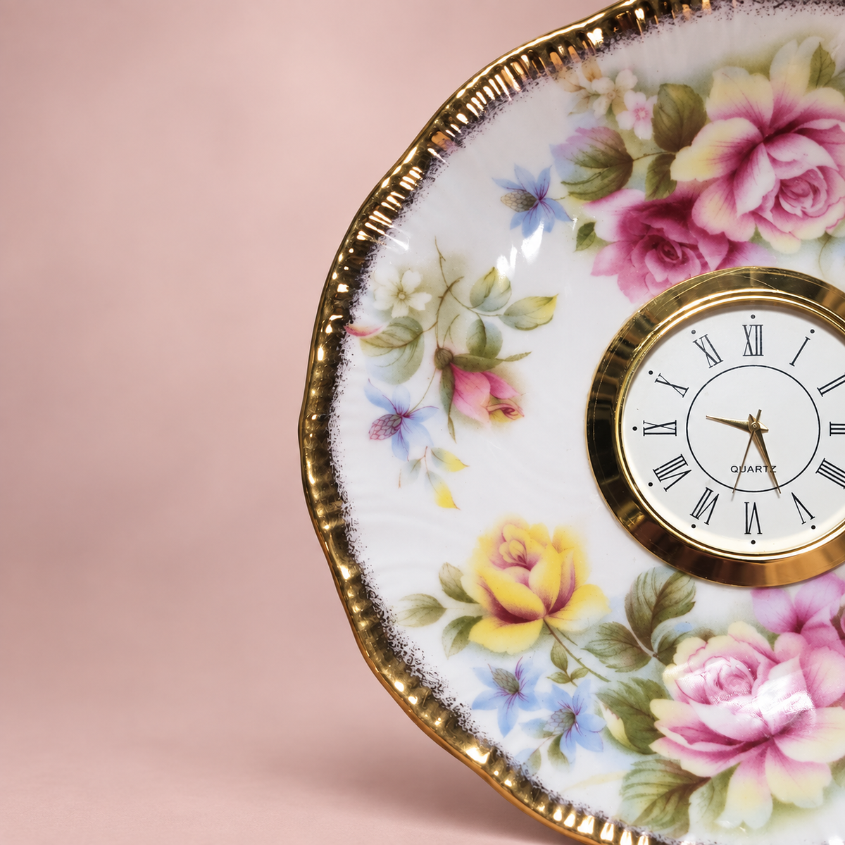 Woodland floral plate clock with a cream-and-olive blossom, colourful foliage and a scalloped gold rim
